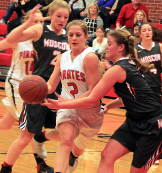 Kylie Tidwell finds heavy going in the lane in the Moscow game. At left is Leah Higgins.