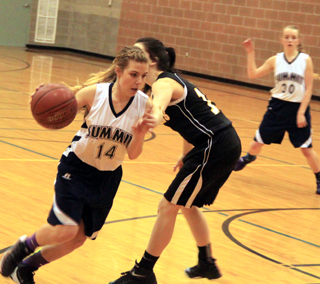 Lexi Currier drives past a Timberline defender in the play-in game Monday. Also shown is Jessie Sonnen.
