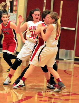 Kylie Tidwell forces a jump ball in the Liberty Charter game. Also shown is Sydney Bruner.