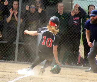 Kylie Tidwell slides home with the game-winning run on a wild pitch in the first Potlatch game.