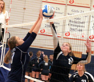 Summit’s Kayla Rehder won this joust at the net with a Logos player at the Grangeville Tournament.