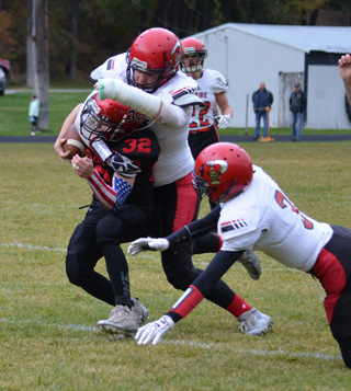Spencer Schumacher engulfs a Wallace runner. Also shown are Owen Anderson, 22, and Dylan Schumacher. Photo by Shari Chaffee.