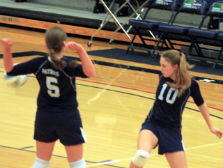 Taylor Lustig and Erin Chmelik back away to let a Kendrick serve go long at District.