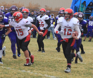 Spencer Schumacher carries the ball for Prairies first touchdown of the game. Caleb McWilliams prepares to block a defender. Also shown are Jace Perrin, behind, McWilliams, and Carson Schmidt, 56.