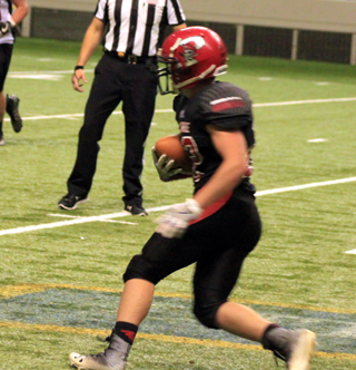 Owen Anderson returns the ball after making an interception that led to the winning touchdown.