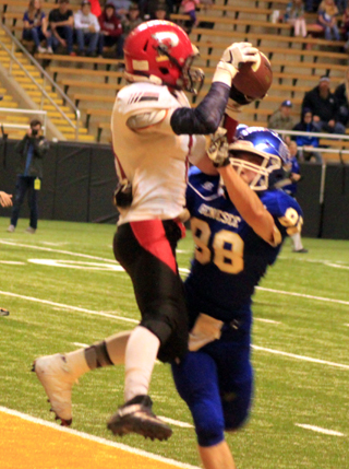Nick Mager leaps above a defender to catch a touchdown pass. He was able to hold on when he got knocked down by #88.