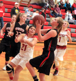 Jordyn Higgins goes for a lay-up at C.V. Also shown are India Peery and Theresa Wemhoff.