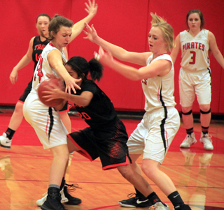 Kristyna Krogh and Leah Higgins doubleteam a Troy player. At right is Angela Wemhoff.