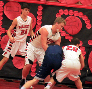Spencer Schumacher and Owen Anderson go after the ball with a Grangeville player as Devin Ross watches. Schumacher got a cut on his chin in the first quarter and had to go with a different uniform due to blood on his usual #32. He wound up as #11 the rest of the game.