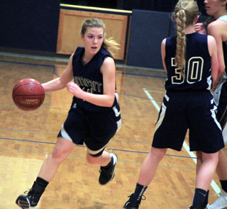 Lexi Currier drives past a pick set by Jessie Sonnen in Summits game at Logos.