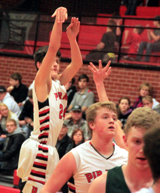 Devin Ross puts up a 3-pointer as Spencer Schumacher watches the flight of the ball.