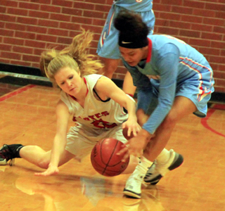 Theresa Wemhoff battles Lapwai’s Amil Mitchell for a loose ball.