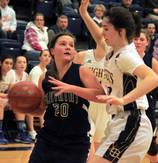 Taylor Lustig tries to maneuver past Logos 62 post Bea Whitling.