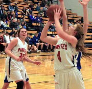 Josie Peery puts up a shot against Genesee. Also shown is Sydney Bruner.