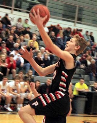 Dylan Schumacher goes for a lay-up at Wallace.