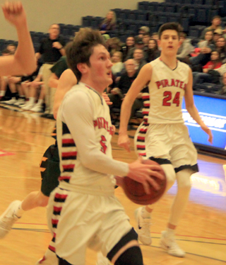 Hunter Chaffee goes for a transition lay-up against Potlatch as Devin Ross looks on.