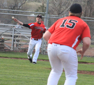 Tate Berdoy, who was pitching at the time, fields an infield grounder and throws to first baseman Dereck Arnzen.