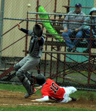 Michael Schwartz slides in safely at home as the throw comes in high vs. Lewis County.