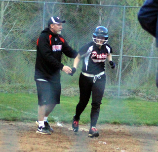 Sarah Ross gets congratulated by coach Jeff Martin as she rounds third after hitting a game-ending 3 run homer at Kendrick. It was her third homer of the day.
