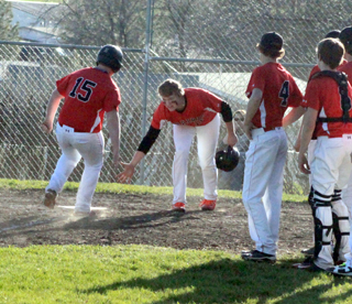 Dereck Arnzen is greeted by Spencer Schumacher at home plate after his 2-run homer against Genesee.