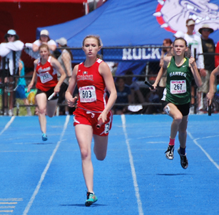 Laney Uhlenkott comes down the final stretch in first place in the 4x200 relay. Photo by Cara Uhlenkott.