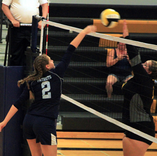 Jade Prigge battles at the net with a Timberline player.