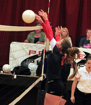 Alexis Hiler blocks a Potlatch spike at the net.