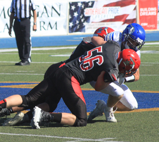 Carson Schmidt and another Prairie defender tackle Valleys quarterback for a loss.
