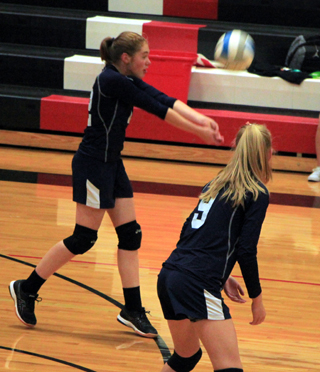 Erin Wassmuth makes a pass against Deary. Also shown is Dani Sonnen.