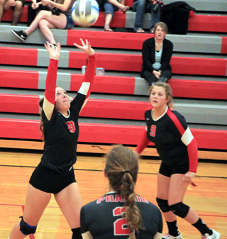 Ashton Landers sets the ball at C.V. Also shown are Hope Schwartz, 9, and Alexis Hiler, 2.