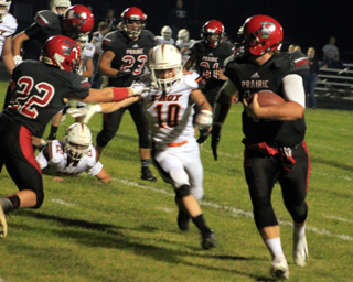 Owen Anderson, 22, gets a block on a Troy defender allowing Spencer Schumacher to go all the way for a touchdown. Other identifiable players are Hayden Uhlenkott, 23, and Reid Uptmor, 81.