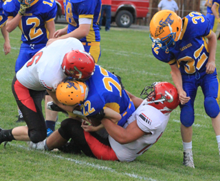 Carson Schmidt and Caleb McWilliams combine on a tackle.