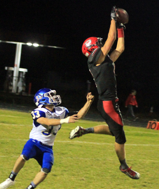 Derik Shears leaps high to make a catch for big yardage against Genesee.