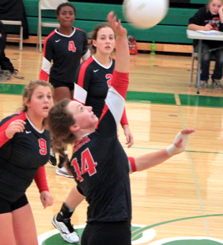 Kristyna Krogh spikes the ball at Potlatch. Also shown from left are Hope Schwartz, Madison Shears and Alexis Hiler.