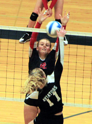 Ellea Poxleitner scores on a block against Compass Charter of Meridian.