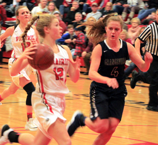 Theresa Wemhoff takes the ball to the hoop after making a steal against Grangeville. Jordyn Higgins is trailing the play.