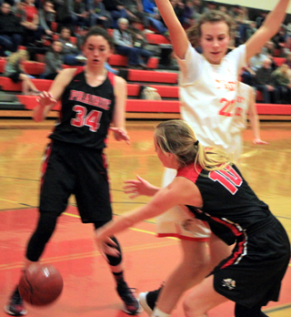 Jordyn Higgins passes around a Troy defender to an open Ciara Chaffee.