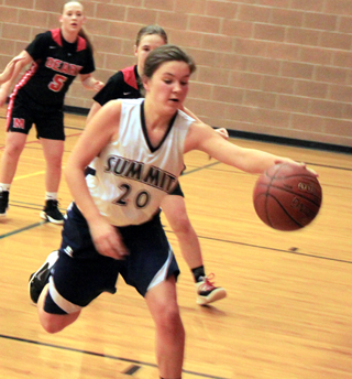 Taylor Lustig retrieves a loose ball under the Summit basket in the Deary game last Friday.
