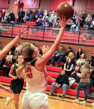 Jordyn Higgins scores 2 of her 22 points on Senior Night against Moscow.