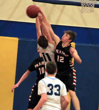 Sam Mager blocks an Ambrose players shot. Also shown is Dylan Schumacher.