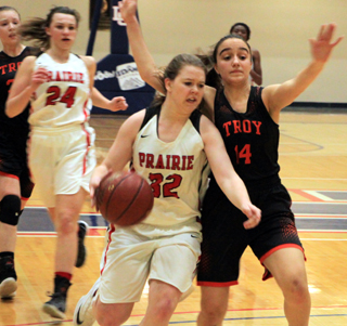 India Peery drives to the hoop against Troy at District. Trailing the play is Kristyna Krogh.