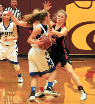 Theresa Wemhoff plays tight defense against Notus. Prairie forced Notus into over 40 turnovers in a big win.