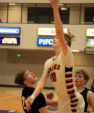 Dylan Schumacher scores a lay-up against Troy.