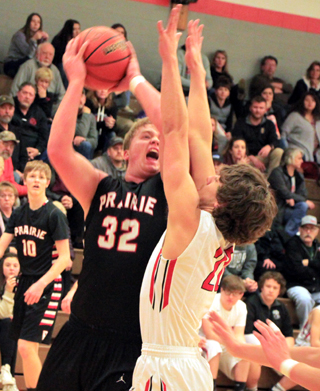 Spencer Schumacher scores against Wallace at Post Falls. Also shown is Dylan Schumacher.
