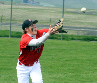 Michael Schwartz is about to catch a fly ball in left field against Troy.