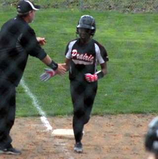 Madison Shears gets congratulated by coach Jeff Martin as she rounds third after a 2-run homer at Kendrick.
