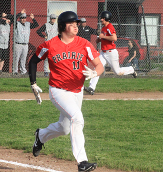 Tate Berdoy can be seen scoring from third as Spencer Schumacher legs out an RBI single at Kamiah.
