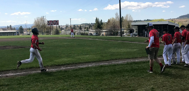 Chase Kaschmitter trots home to be greeted by the team after a home run against Kendrick. Photo by John Mager.