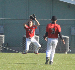 Lane Remacle struggles with a fly ball against C.V. but was able to make the catch. Also shown is Dalton Ross.