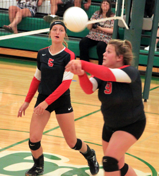 Hope Schwartz sends the ball over the net at Potlatch as Elea Uhlenkott watches.